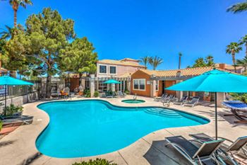 Madison at Black Mountain apartments in Henderson, NV 89015 photo of a resort style pool with lounge chairs and umbrellas